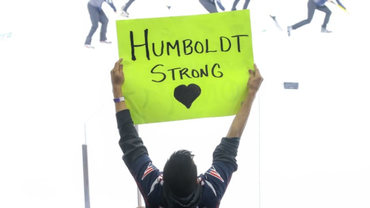 WINNIPEG, MB - APRIL 7: A fan holds up a sign in support of the Humboldt Broncos during third period action between the Winnipeg Jets and the Chicago Blackhawks at the Bell MTS Place on April 7, 2018 in Winnipeg, Manitoba, Canada. The Broncos lost members of their team in a motor vehicle accident on April 6, 2018.The Jets defeated the Bruins 5-4 in the shootout. (Photo by Jonathan Kozub/NHLI via Getty Images)