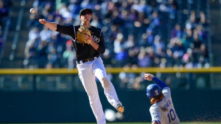 DENVER, CO - APRIL 9: DJ LeMahieu #9 of the Colorado Rockies throws to first base to complete a double play after forcing out Justin Turner #10 of the Los Angeles Dodgers in the eighth inning of a game at Coors Field on April 9, 2017 in Denver, Colorado. (Photo by Dustin Bradford/Getty Images)