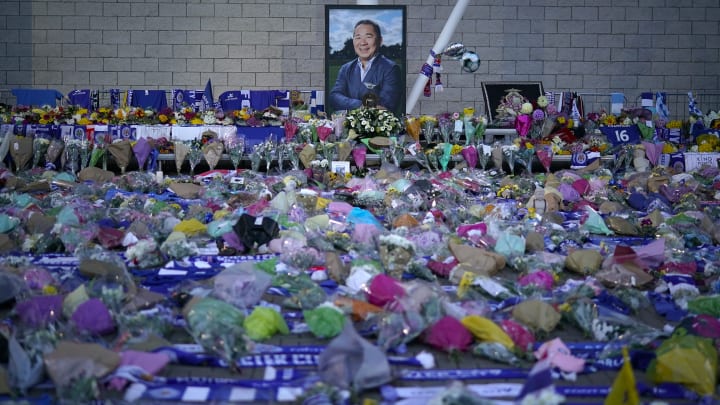 LEICESTER, ENGLAND – OCTOBER 29: A portrait of Leicester City Football Club’s Thai chairman Vichai Srivaddhanaprabha who died in a helicopter crash, looks out over a sea of tributes at Leicester City Football Club’s King Power Stadium on October 28, 2018 in Leicester, England. The owner of Leicester City Football Club, Vichai Srivaddhanaprabha, was among the five people who died in the helicopter crash on Saturday evening after the club’s game against West Ham. (Photo by Christopher Furlong/Getty Images)