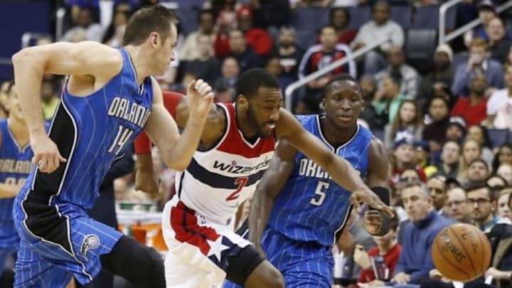 Jan 1, 2016; Washington, DC, USA; Washington Wizards guard John Wall (2), Orlando Magic forward Jason Smith (14), and Magic guard Victor Oladipo (5) chase a loose ball in the fourth quarter at Verizon Center. The Wizards won 103-91. Mandatory Credit: Geoff Burke-USA TODAY Sports