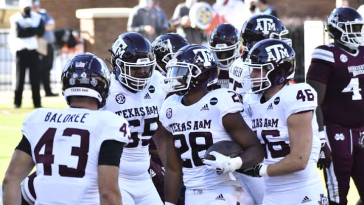 Oct 17, 2020; Starkville, Mississippi, USA; Texas A&M Aggies running back Isaiah Spiller (28) reacts with teammates after a touchdown against the Mississippi State Bulldogs during the second quarter at Davis Wade Stadium at Scott Field. Mandatory Credit: Matt Bush-USA TODAY Sports