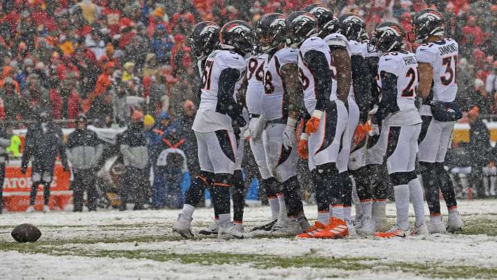 The Denver Broncos huddles up before a play (Photo by Peter Aiken/Getty Images)