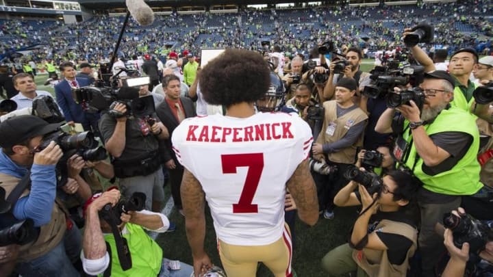 Sep 25, 2016; Seattle, WA, USA; San Francisco 49ers quarterback Colin Kaepernick (7) meets with Seattle Seahawks wide receiver Doug Baldwin (89) after a game at CenturyLink Field. The Seahawks won 37-18. Mandatory Credit: Troy Wayrynen-USA TODAY Sports