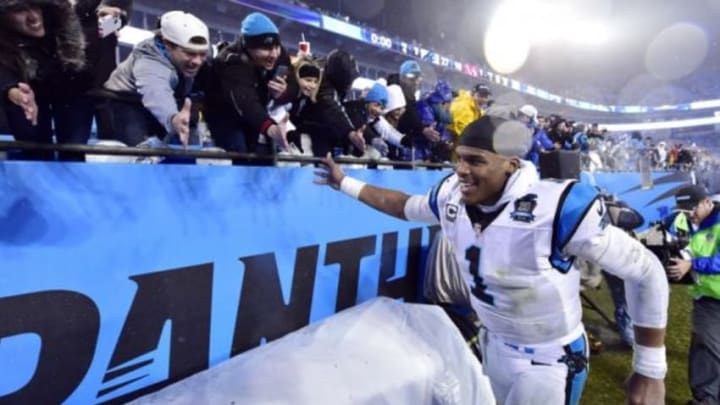 Jan 3, 2015; Charlotte, NC, USA; Carolina Panthers quarterback Cam Newton (1) celebrates with fans after beating the Arizona Cardinals in the 2014 NFC Wild Card playoff football game at Bank of America Stadium. Mandatory Credit: Jeremy Brevard-USA TODAY Sports