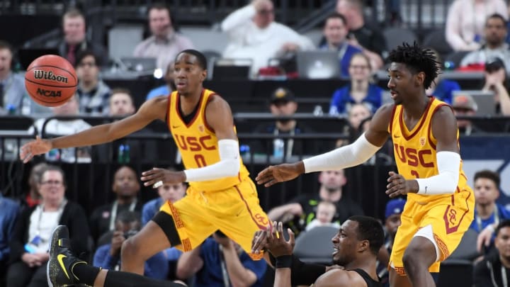 LAS VEGAS, NV – MARCH 09: MiKyle McIntosh #22 of the Oregon Ducks passes from the floor in front of Shaqquan Aaron #0 and Jonah Mathews #2 of the USC Trojans during a semifinal game of the Pac-12 basketball tournament at T-Mobile Arena on March 9, 2018 in Las Vegas, Nevada. The Trojans won 74-54. (Photo by Ethan Miller/Getty Images)