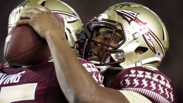 Oct 18, 2014; Tallahassee, FL, USA; Florida State Seminoles quarterback Jameis Winston (5) hugs offensive tackle Cameron Erving (75) during pre game warmups before their game against the Notre Dame Fighting Irish at Doak Campbell Stadium. Mandatory Credit: John David Mercer-USA TODAY Sports
