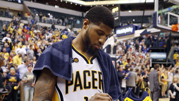 Apr 12, 2017; Indianapolis, IN, USA; Indiana Pacers forward Paul George (13) autographs shoes and tosses them to the fans after the game against the Atlanta Hawks at Bankers Life Fieldhouse. Indiana defeats Atlanta 104-86. Mandatory Credit: Brian Spurlock-USA TODAY Sports