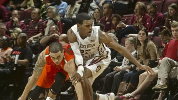 Feb 1, 2015; Tallahassee, FL, USA; Miami Hurricanes guard Angel Rodriguez (13) and Florida State Seminoles guard Xavier Rathan-Mayes (22) battle for the ball in the second half at the Donald L. Tucker Center. The Seminoles won 55-54. Mandatory Credit: Phil Sears-USA TODAY Sports