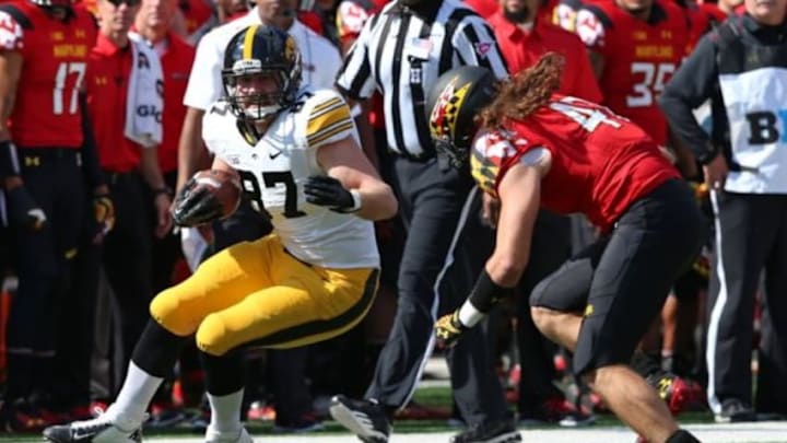 Oct 18, 2014; College Park, MD, USA; Iowa Hawkeyes tight end Jake Duzey (87) attempts to gain yardage in front of Maryland Terrapins linebacker Cole Farrand (47) at Byrd Stadium. Mandatory Credit: Mitch Stringer-USA TODAY Sports