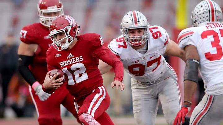 Oct 3, 2015; Bloomington, IN, USA; Indiana Hoosiers quarterback Zander Diamont (12) runs by Ohio State Buckeyes defensive lineman Joey Bosa (97) in the fourth quarter of their game at Memorial Stadium. Mandatory Credit: Matt Kryger-USA TODAY Sports