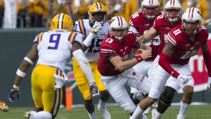 Sep 3, 2016; Green Bay, WI, USA; Wisconsin Badgers quarterback Bart Houston (13) rushes with the football during the second quarter against the LSU Tigers at Lambeau Field. Mandatory Credit: Jeff Hanisch-USA TODAY Sports