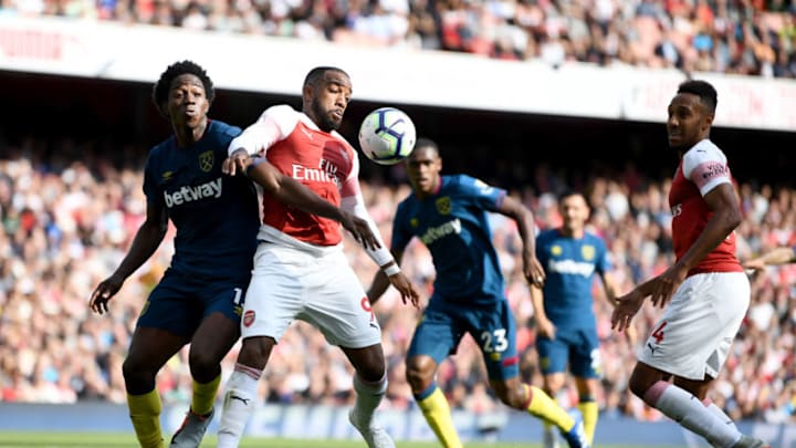LONDON, ENGLAND - AUGUST 25: Alexandre Lacazette of Arsenal is challenged by Carlos Sanchez of West Ham United during the Premier League match between Arsenal FC and West Ham United at Emirates Stadium on August 25, 2018 in London, United Kingdom. (Photo by Clive Mason/Getty Images)