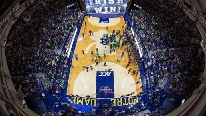 Jan 4, 2014; South Bend, IN, USA; Fans rush the court after the Notre Dame Fighting Irish defeated the Duke Blue Devils 79-77 at the Purcell Pavilion. Mandatory Credit: Matt Cashore-USA TODAY Sports