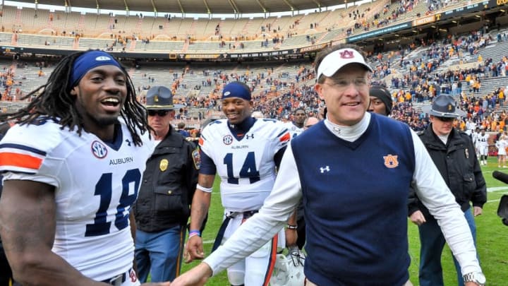 Nov 9, 2013; Knoxville, TN, USA; Auburn Tigers head coach Gus Malzahn leaves the field with Auburn wide receiver Sammie Coates (18) followed by Auburn quarterback Nick Marshall (14) after defeating the Tennessee Volunteers 55-23 at Neyland Stadium. Mandatory Credit: Jim Brown-USA TODAY Sports