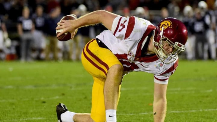 PASADENA, CA - JANUARY 02: Quarterback Sam Darnold #14 of the USC Trojans stumbles prior to throwing a touchdown pass in the third quarter against the Penn State Nittany Lions during the 2017 Rose Bowl Game presented by Northwestern Mutual at the Rose Bowl on January 2, 2017 in Pasadena, California. (Photo by Harry How/Getty Images)