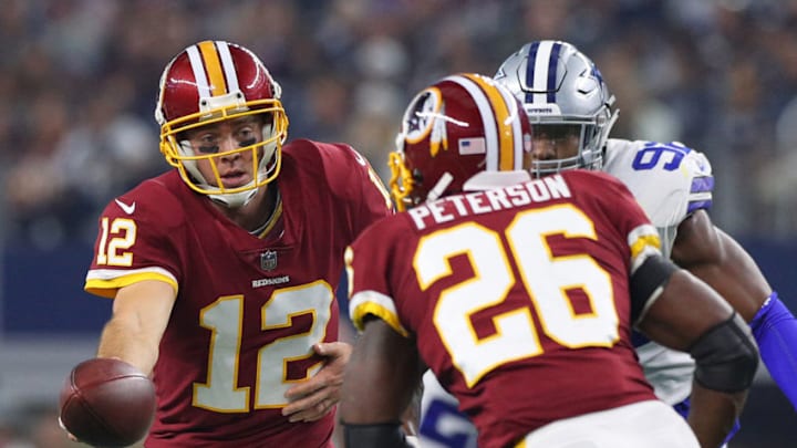 ARLINGTON, TEXAS - NOVEMBER 22: Colt McCoy #12 hands the ball off to Adrian Peterson #26 of the Washington Redskins in a football game at AT&T Stadium on November 22, 2018 in Arlington, Texas. (Photo by Richard Rodriguez/Getty Images)