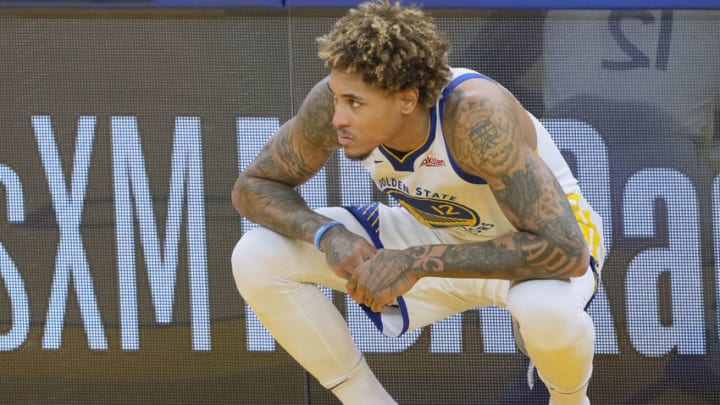SAN FRANCISCO, CALIFORNIA - MARCH 26: Kelly Oubre Jr. #12 of the Golden State Warriors looks on while waiting to come in to the game against the Atlanta Hawks during the first half of an NBA basketball game at Chase Center on March 26, 2021 in San Francisco, California. NOTE TO USER: User expressly acknowledges and agrees that, by downloading and or using this photograph, User is consenting to the terms and conditions of the Getty Images License Agreement. (Photo by Thearon W. Henderson/Getty Images)