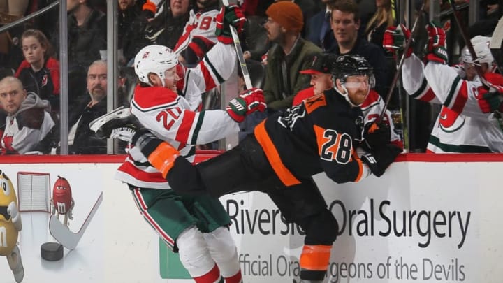 NEWARK, NJ - MARCH 01: Blake Coleman #20 of the New Jersey Devils and Claude Giroux #28 of the Philadelphia Flyers come together at the boards during the game at Prudential Center on March 1, 2019 in Newark, New Jersey. (Photo by Andy Marlin/NHLI via Getty Images)