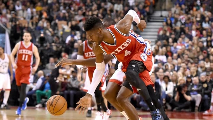 Apr 12, 2016; Toronto, Ontario, CAN; Philadelphia 76ers center Nerlens Noel (4) chases the ball after stealing it from Toronto Raptors center Bismack Biyombo (8) in the first half at Air Canada Centre. Mandatory Credit: Dan Hamilton-USA TODAY Sports