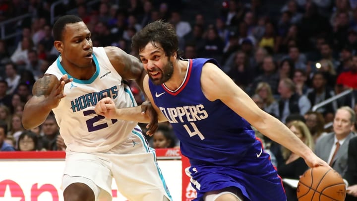 LOS ANGELES, CA – DECEMBER 31: Milos Teodesic #4 of the LA Clippers pushes the ball past Trevor Graham #21 of the Charlotte Hornets in the third quarter at Staples Center on December 31, 2017 in Los Angeles, California. NOTE TO USER: User expressly acknowledges and agrees that, by downloading and or using this photograph, User is consenting to the terms and conditions of the Getty Images License Agreement. (Photo by Joe Scarnici/Getty Images)