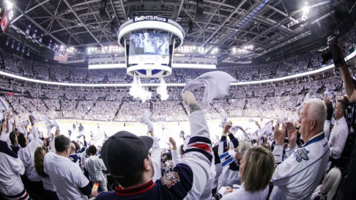 WINNIPEG, MB April 11: Winnipeg Jets fans embrace the 'whiteout' during the Stanley Cup Playoffs First Round Game 1 between the Winnipeg Jets and the Minnesota Wild on April 11, 2018 at the Bell MTS Place in Winnipeg MB. (Photo by Terrence Lee/Icon Sportswire via Getty Images)