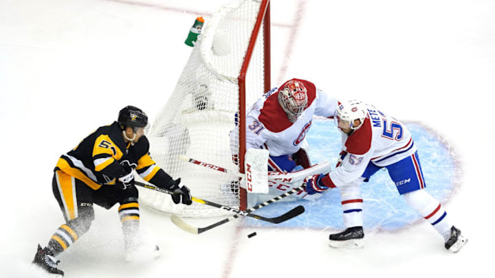 TORONTO, ONTARIO - AUGUST 01: Teddy Blueger #53 of the Pittsburgh Penguins wraps around the net as Carey Price #31 and Victor Mete #53 of the Montreal Canadiens make the stop in the first period in Game One of the Eastern Conference Qualification Round prior to the 2020 NHL Stanley Cup Playoffs at Scotiabank Arena on August 01, 2020 in Toronto, Ontario. (Photo by Andre Ringuette/Freestyle Photo/Getty Images)