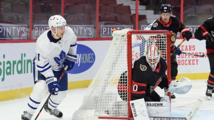 Zach Hyman #11 of the Toronto Maple Leafs skates with the puck as Matt Murray #30 of the Ottawa Senators defends his net. (Photo by Matt Zambonin/Freestyle Photography/Getty Images)