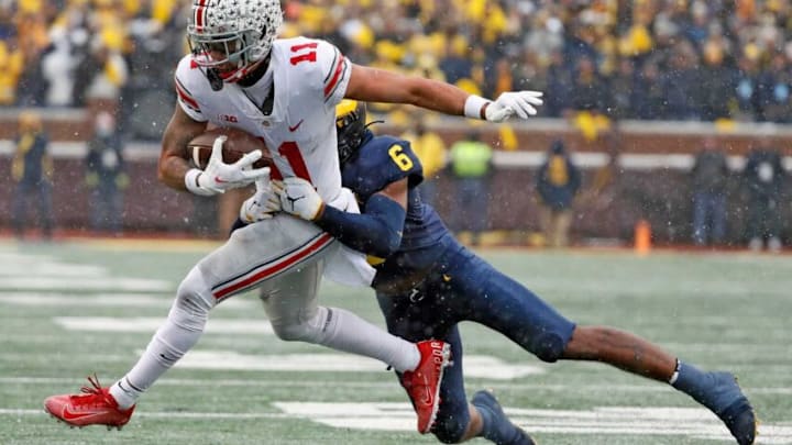 Ohio State Buckeyes wide receiver Jaxon Smith-Njigba (11) is tackled by Michigan Wolverines defensive back R.J. Moten (6) after a catch during the second quarter of their NCAA College football at Michigan Stadium at Ann Arbor, Mi on November 27, 2021.Osu21um Kwr 32 Ohio State Buckeyes wide receiver Jaxon Smith-Njigba (11) is tackled by Michigan Wolverines defensive back R.J. Moten (6) after a catch during the second quarter of their NCAA College football at Michigan Stadium at Ann Arbor, Mi on November 27, 2021.Osu21um Kwr 32