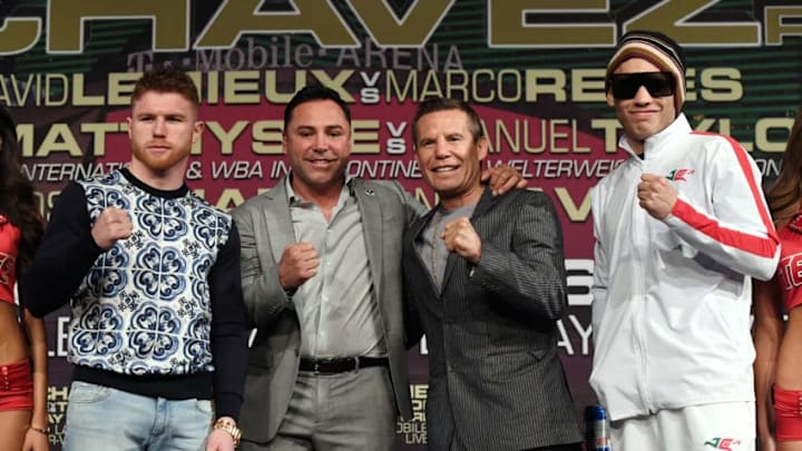 LAS VEGAS, NV - MAY 03: (L-R) Boxer Canelo Alvarez, Chairman and CEO of Golden Boy Promotions Oscar De La Hoya, former boxer Julio Cesar Chavez Sr. and his son, boxer Julio Cesar Chavez Jr., pose during a news conference at the KA Theatre at MGM Grand Hotel