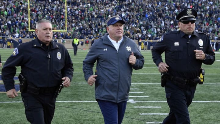 SOUTH BEND, IN - OCTOBER 13: Notre Dame Fighting Irish head coach Brian Kelly is escorted off the field after defeating the Pittsburgh Panthers at Notre Dame Stadium on October 13, 2018 in South Bend, Indiana. (Photo by Quinn Harris/Getty Images)