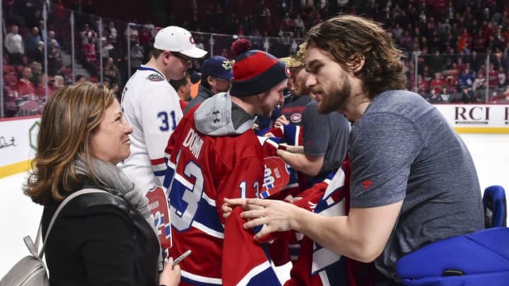 MONTREAL, QC - APRIL 06: Jonathan Drouin #92 of the Montreal Canadiens hands over his jersey to a fan after defeating the Toronto Maple Leafs 6-5 in a shootout during the NHL game at the Bell Centre on April 6, 2019 in Montreal, Quebec, Canada. (Photo by Minas Panagiotakis/Getty Images)