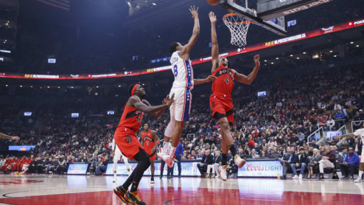 TORONTO, ON - OCTOBER 28: Scottie Barnes #4 of the Toronto Raptors tries to block a shot by Shake Milton #18 of the Philadelphia 76ers (Photo by Cole Burston/Getty Images