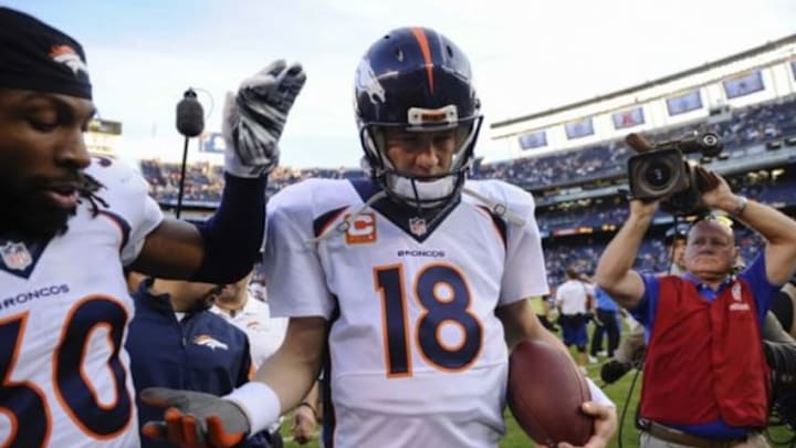 Dec 14, 2014; San Diego, CA, USA; Denver Broncos quarterback Peyton Manning (18) and Denver Broncos strong safety David Bruton (30) celebrate beating the San Diego Chargers at Qualcomm Stadium. Mandatory Credit: Robert Hanashiro-USA TODAY Sports