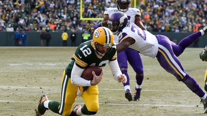 GREEN BAY, WI - DECEMBER 24: Aaron Rodgers #12 of the Green Bay Packers rushes for a touchdown during the second quarter of a game of a game against the Minnesota Vikings at Lambeau Field on December 24, 2016 in Green Bay, Wisconsin. (Photo by Stacy Revere/Getty Images)