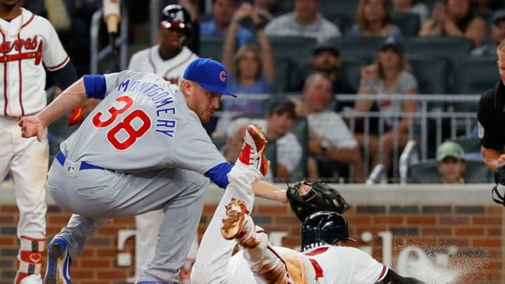 ATLANTA, GA - MAY 15: Johan Camargo #17 of the Atlanta Braves is called out as he attempts to steal homeplate on a wild pitch by Mike Montgomery #38 of the Chicago Cubs in the fifth inning at SunTrust Park on May 15, 2018 in Atlanta, Georgia. (Photo by Kevin C. Cox/Getty Images)