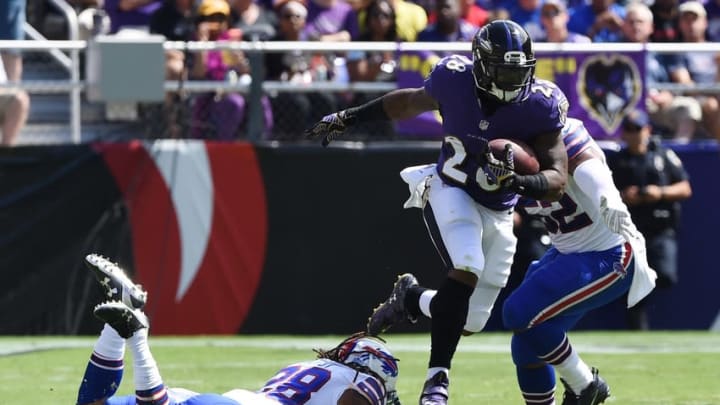 Sep 11, 2016; Baltimore, MD, USA; Baltimore Ravens running back Terrance West (28) leaps over Buffalo Bills cornerback Ronald Darby (28) during the second quarter at M&T Bank Stadium. Mandatory Credit: Tommy Gilligan-USA TODAY Sports