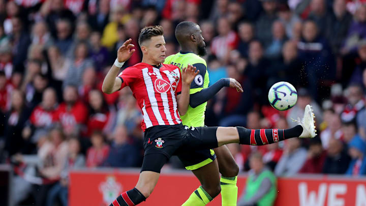 SOUTHAMPTON, ENGLAND – MAY 12: Jan Bednarek of Southampton defends the ball against Isaac Mbenza of Huddersfield Town during the Premier League match between Southampton FC and Huddersfield Town at St Mary’s Stadium on May 12, 2019 in Southampton, United Kingdom. (Photo by David Cannon/Getty Images)