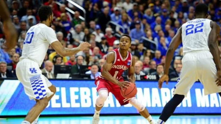 Mar 19, 2016; Des Moines, IA, USA; Indiana Hoosiers guard Yogi Ferrell (11) handles the ball against Kentucky Wildcats forward Marcus Lee (00) and forward Alex Poythress (22) in the second half during the second round of the 2016 NCAA Tournament at Wells Fargo Arena. Mandatory Credit: Jeffrey Becker-USA TODAY Sports
