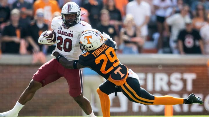 South Carolina running back Kevin Harris (20) is grabbed by Tennessee defensive back Brandon Turnage on Saturday in Knoxville, Tenn.Utvsc1007