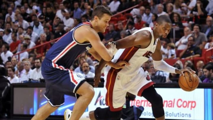 Oct 29, 2014; Miami, FL, USA; Miami Heat forward Chris Bosh (1) dribbles as Washington Wizards forward Kris Humphries (43) defends during the second half at American Airlines Arena. Miami won 107-95. Mandatory Credit: Steve Mitchell-USA TODAY Sports