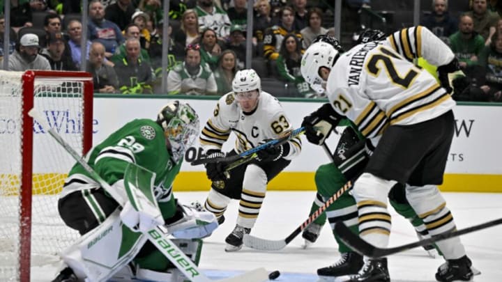 Nov 6, 2023; Dallas, Texas, USA; Dallas Stars goaltender Jake Oettinger (29) and Boston Bruins left wing Brad Marchand (63) and left wing James van Riemsdyk (21) look for the loose puck in the crease during the first period at the American Airlines Center. Mandatory Credit: Jerome Miron-USA TODAY Sports