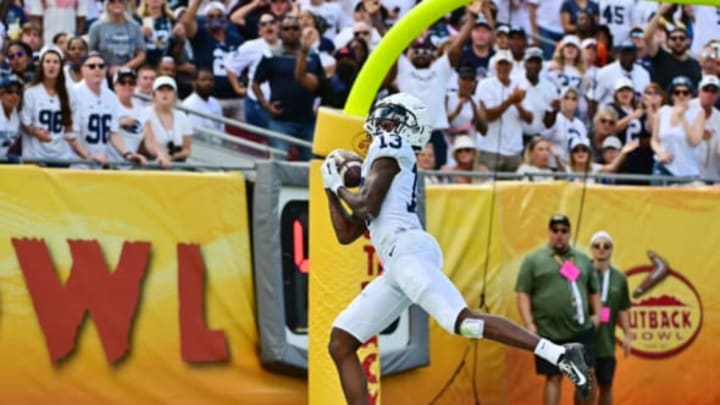 TAMPA, FLORIDA – JANUARY 01: Wide receiver KeAndre Lambert-Smith #13 of the Penn State Nittany Lions catches a 42-yard touchdown pass thrown by Sean Clifford during the second quarter against the Arkansas Razorbacks in the 2022 Outback Bowl at Raymond James Stadium on January 01, 2022 in Tampa, Florida. (Photo by Julio Aguilar/Getty Images)