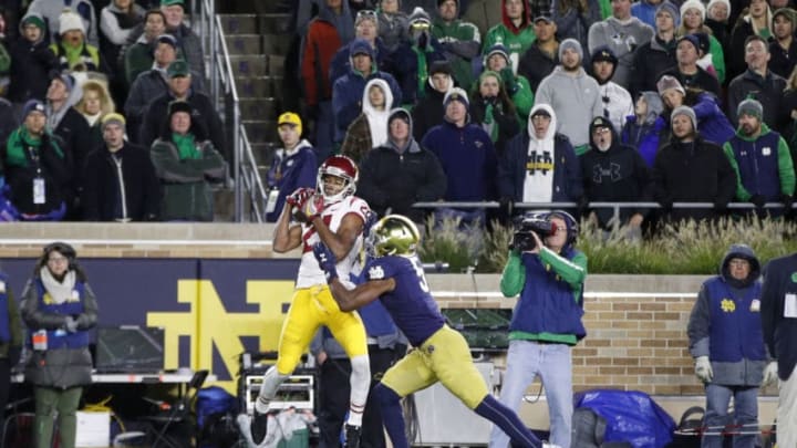 SOUTH BEND, IN - OCTOBER 12: Tyler Vaughns #21 of the USC Trojans makes a five-yard touchdown reception behind Troy Pride Jr. #5 of the Notre Dame Fighting Irish in the second half of the game at Notre Dame Stadium on October 12, 2019 in South Bend, Indiana. Notre Dame defeated USC 30-27. (Photo by Joe Robbins/Getty Images)