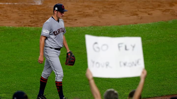 NEW YORK, NY - OCTOBER 09: Trevor Bauer #47 of the Cleveland Indians walks back to the dugout as a fan holds a sign that reads, "GO FLY YOUR DRONE" after being relieved during the second inning against the New York Yankees in Game Four of the American League Divisional Series at Yankee Stadium on October 9, 2017 in the Bronx borough of New York City. (Photo by Mike Stobe/Getty Images)