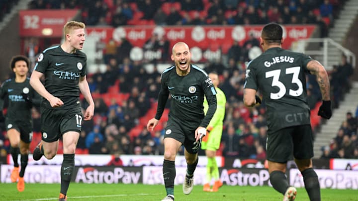 STOKE ON TRENT, ENGLAND - MARCH 12: David Silva of Manchester City (21) celebrates as he scores their second goal with Kevin De Bruyne and Gabriel Jesus during the Premier League match between Stoke City and Manchester City at Bet365 Stadium on March 12, 2018 in Stoke on Trent, England. (Photo by Michael Regan/Getty Images)
