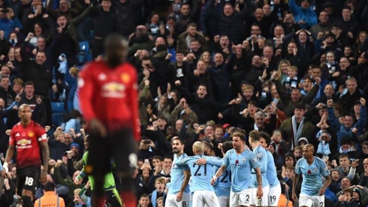 Manchester City's German midfielder Ilkay Gundogan celebrates with teammates after scoring their third goal during the English Premier League football match between Manchester City and Manchester United at the Etihad Stadium in Manchester, north west England, on November 11, 2018. (Photo by Oli SCARFF / AFP) / RESTRICTED TO EDITORIAL USE. No use with unauthorized audio, video, data, fixture lists, club/league logos or 'live' services. Online in-match use limited to 120 images. An additional 40 images may be used in extra time. No video emulation. Social media in-match use limited to 120 images. An additional 40 images may be used in extra time. No use in betting publications, games or single club/league/player publications. / (Photo credit should read OLI SCARFF/AFP/Getty Images)