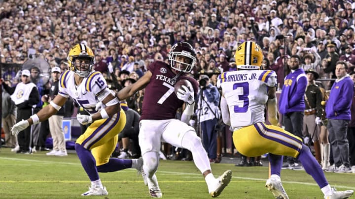 Nov 26, 2022; College Station, Texas, USA; Texas A&M Aggies wide receiver Moose Muhammad III (7) scores a touchdown against LSU Tigers safety Sage Ryan (15) and safety Greg Brooks Jr (3) during the fourth quarter at Kyle Field. Mandatory Credit: Maria Lysaker-USA TODAY Sports