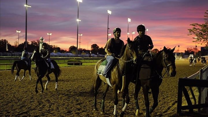 May 2, 2013; Louisville, KY, USA; Exercise riders work their horses during early morning workouts at Churchill Downs. Mandatory Credit: Jamie Rhodes-USA TODAY Sports