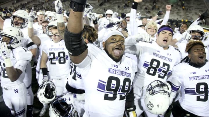 IOWA CITY, IOWA- NOVEMBER 10: Defensive lineman Jordan Thompson #99 of the Northwestern Wildcats joins teammates in singing their fight song after they defeated the Iowa Hawkeyes, on November 10, 2018 at Kinnick Stadium, in Iowa City, Iowa. (Photo by Matthew Holst/Getty Images)