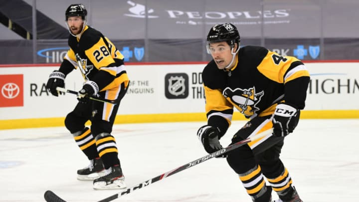 PITTSBURGH, PENNSYLVANIA - FEBRUARY 20: Cody Ceci #4 of the Pittsburgh Penguins and Marcus Pettersson #28 skate down the ice during their game against the New York Islanders at PPG PAINTS Arena on February 20, 2021 in Pittsburgh, Pennsylvania. (Photo by Emilee Chinn/Getty Images)